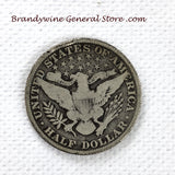 A 1915 Barber Half dollar coin in good plus condition with minor rim damage for sale by Brandywine General Store reverese of coin