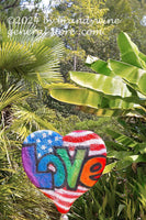 art print of Love sculpture in front of tropical plants