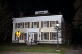 An art print of Yellow House in Cooperstown at Night with Street Lamp