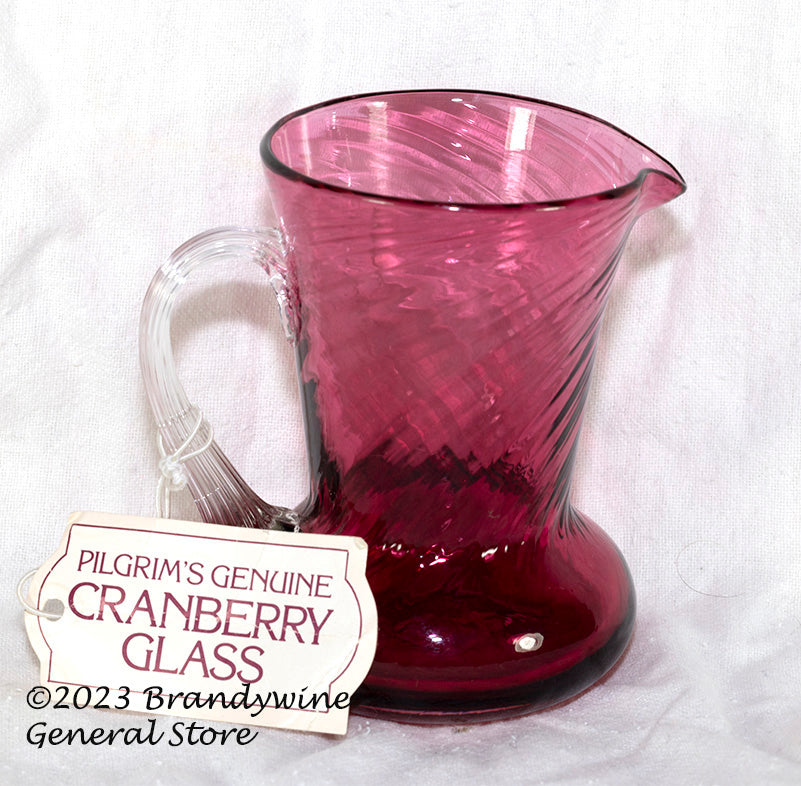 https://www.brandywinegeneralstore.com/cdn/shop/products/Pilgrims-Cranberry-Glass-Small-Pitcher-with-Tag.jpg?v=1681181709