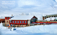 A Snowy Landscape with a Red Train Station premium print